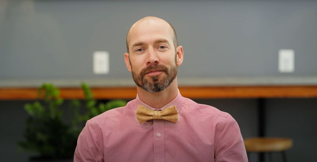 Bearded patient in a pink shirt and bow tie at Thrive Family Dental in Wilmington, NC